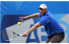 EASTBOURNE, ENGLAND - JUNE 14: Chris Guccione of Australia plays a backhand against Scott Clayton of Great Britain during their Men's Singles qualifying match on day one of the Aegon International at Devonshire Park on June 14, 2014 in Eastbourne, England.  (Photo by Steve Bardens/Getty Images)